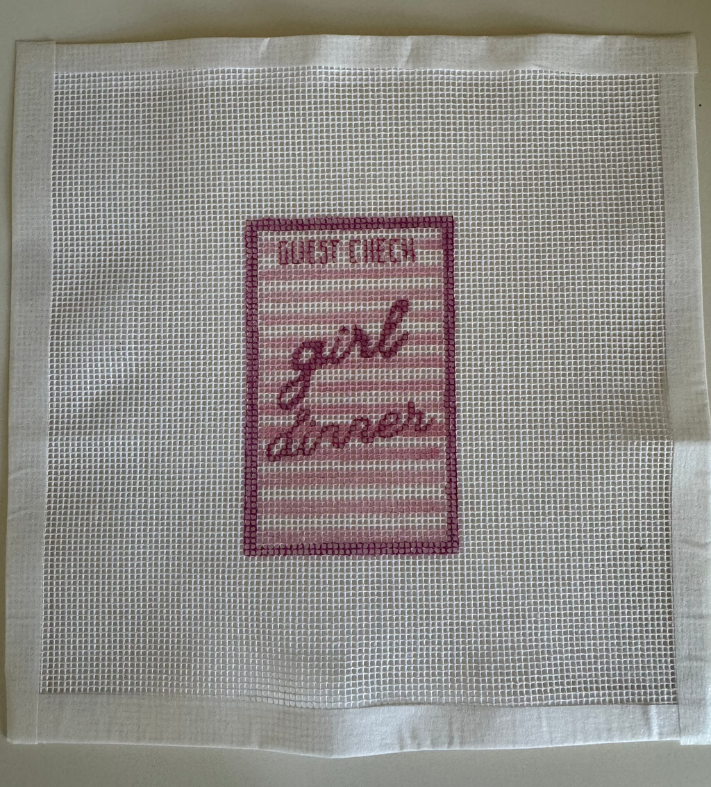 Needlepoint Design with 'Girl Dinner' text on a white background